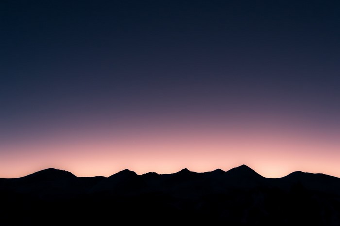 Silhouette of mountains against a twilight sky