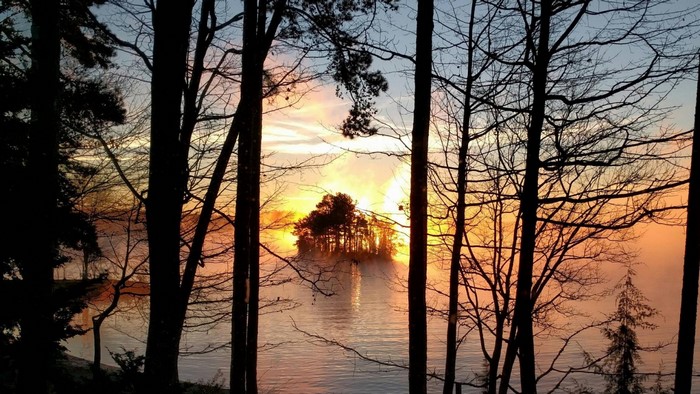 Sunrise over Lake Keowee with island and trees
