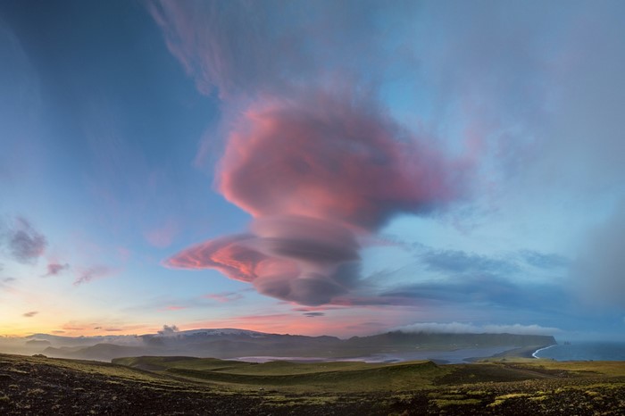 Pink clouds over a coastal landscape at sunset