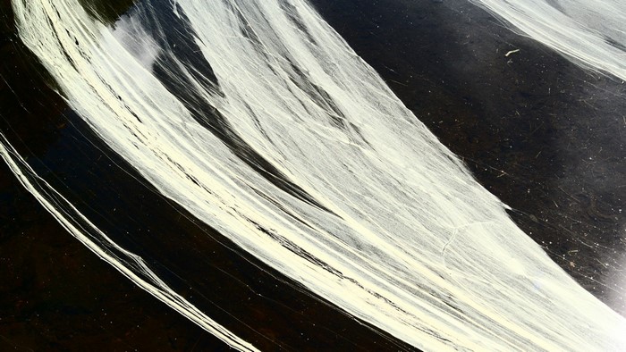 Abstract pattern of white lines on black surface