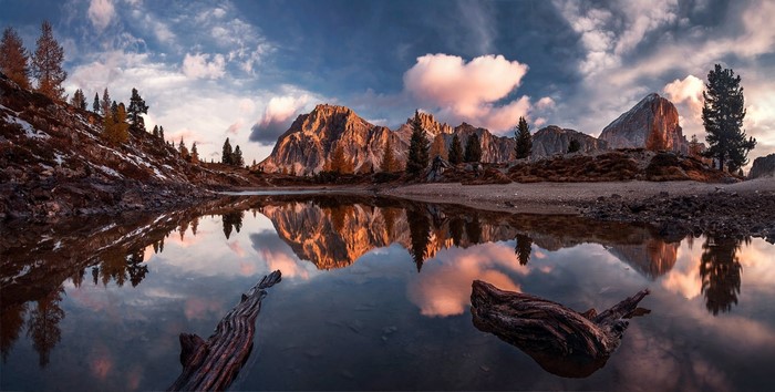 Mountain lake reflection at sunset in the Dolomites, Italy