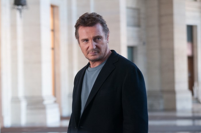 Liam Neeson in a black suit