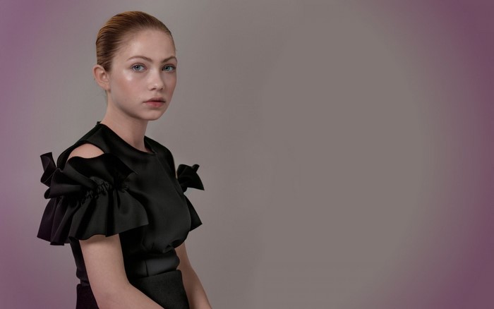 Woman in black dress with ruffled sleeves