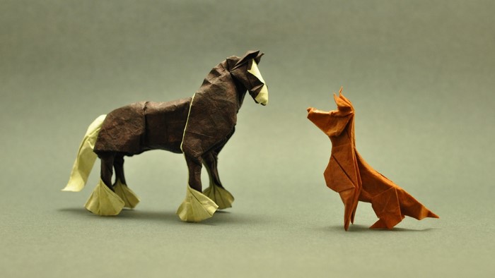 Origami horse and dog facing each other