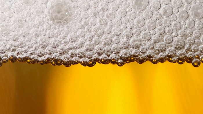 Close-up of beer foam and bubbles