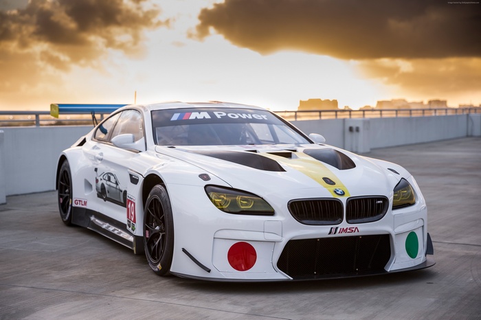 White BMW M6 GTLM race car with yellow stripe