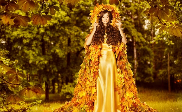 Woman in a dress made of autumn leaves