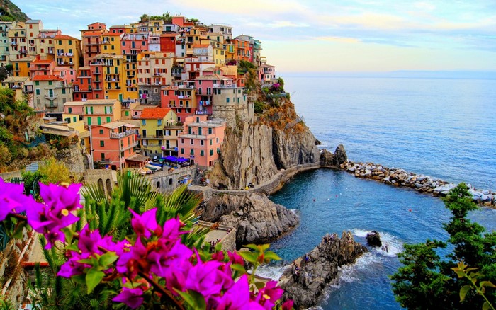 Colorful buildings on a cliff overlooking the sea in Manarola, Italy