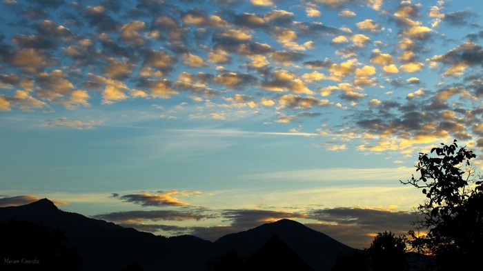 Sunset over mountains with clouds
