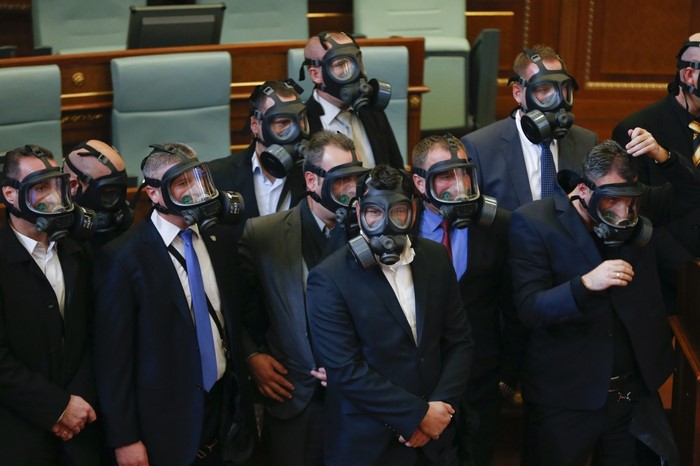Politicians wearing gas masks in Kosovo