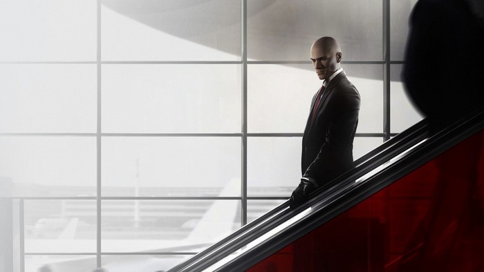 Agent 47 from Hitman on an escalator