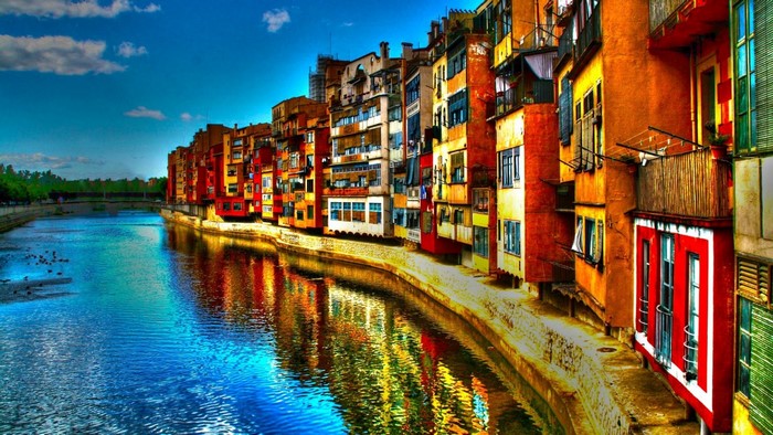 Colorful buildings along a river in a European city