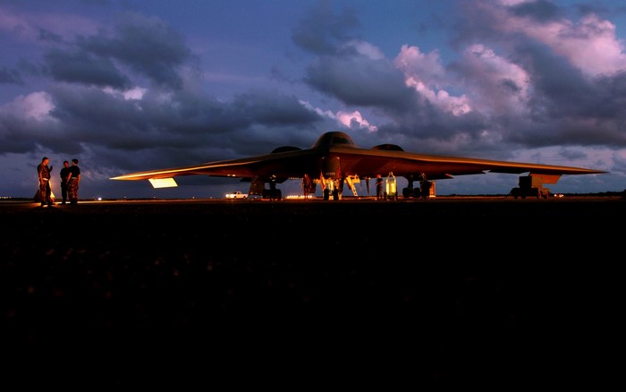 Northrop Grumman B-2 Spirit bomber on tarmac at dusk