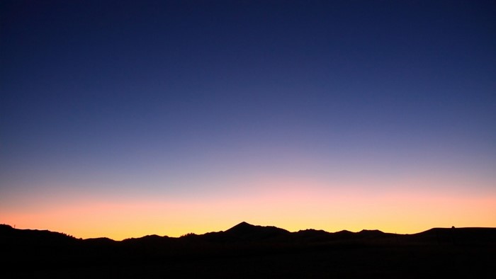 Silhouette of mountains against a twilight sky