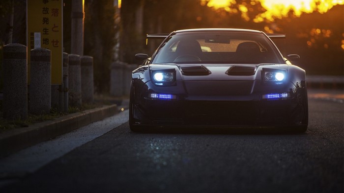 Front view of a dark blue Honda NSX sports car at sunset