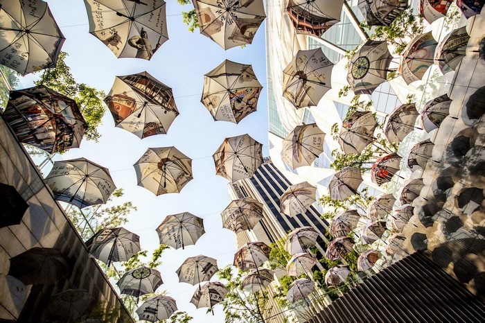Umbrellas decorated with city scenes hanging outdoors