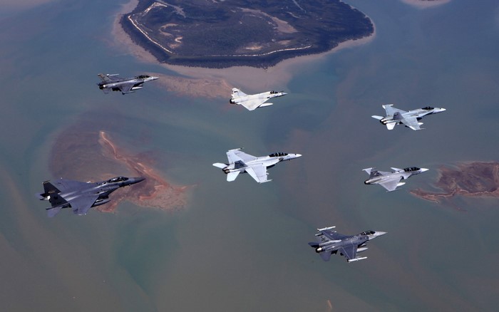 Fighter jets flying over coastal waters