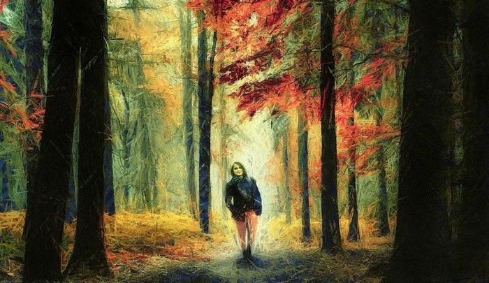 Woman walking in a sunlit autumn forest