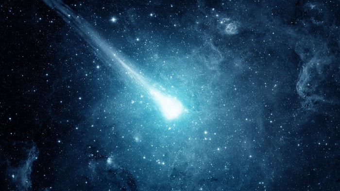 Comet streaking through a starry nebula
