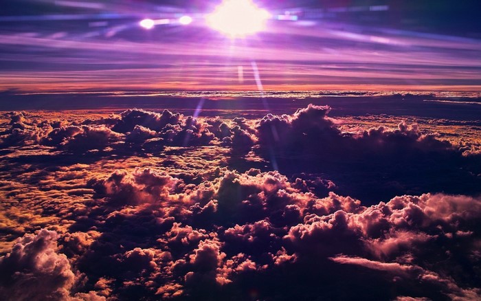 Sunlight over clouds at sunset