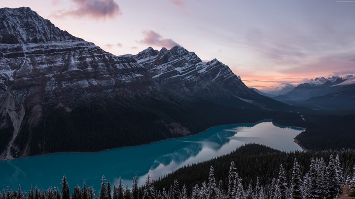 Snow-capped mountains and turquoise lake at sunset
