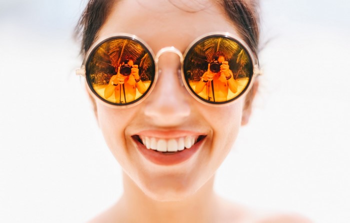 Woman wearing sunglasses with reflection
