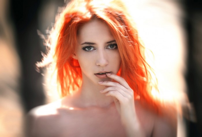 Woman with vibrant red hair posing for a portrait