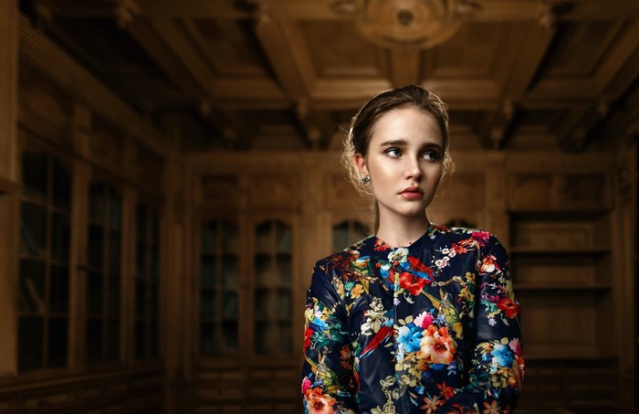 Woman in floral jacket in ornate room