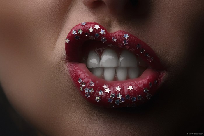 Woman with red lipstick and star glitter