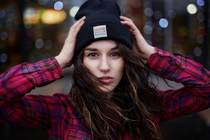 Woman in beanie and plaid shirt