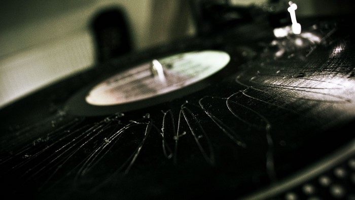 Close-up of a scratched vinyl record on a turntable