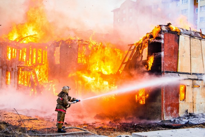Firefighter battling a house fire
