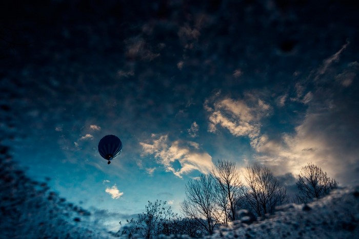 Reflection of a hot air balloon in the sky at sunset