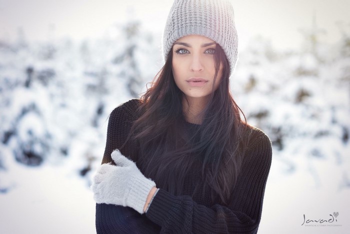 Woman in beanie and gloves in snow