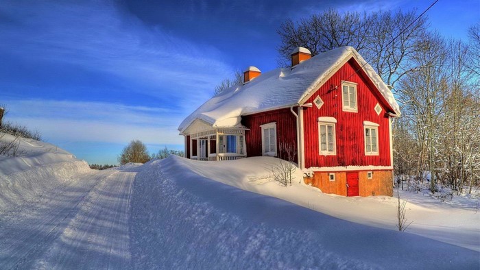 Red house in snow with winter landscape