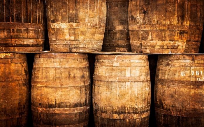 Stacked wooden barrels in a cellar