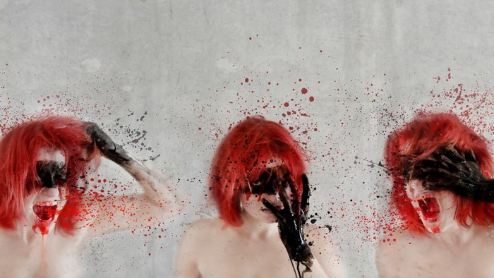 Three women with red hair and black paint on faces