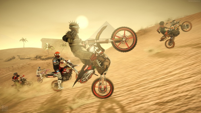 Motocross riders performing stunts in a desert with pyramids