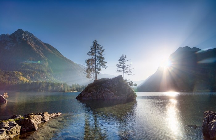 Sunrise over Mountain Lake with Trees on Rock