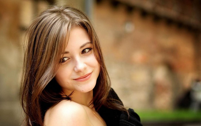Portrait of a Smiling Woman with Long Brown Hair