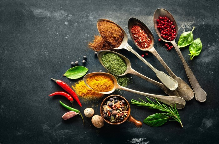 Assortment of Spices and Peppers on Dark Surface