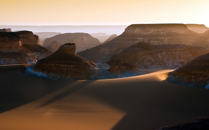 Desert landscape with rock formations and sand dunes