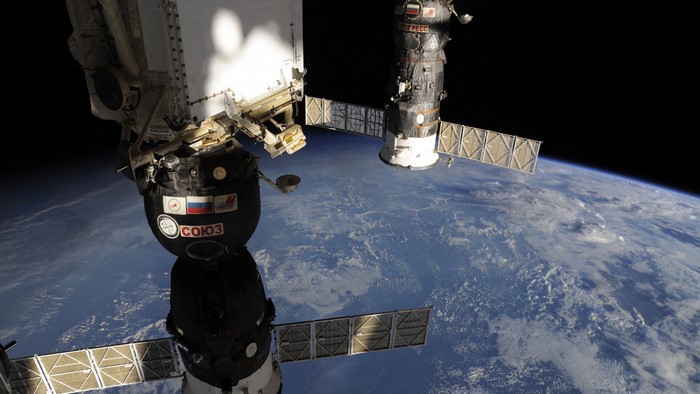Soyuz spacecraft docked with International Space Station over Earth