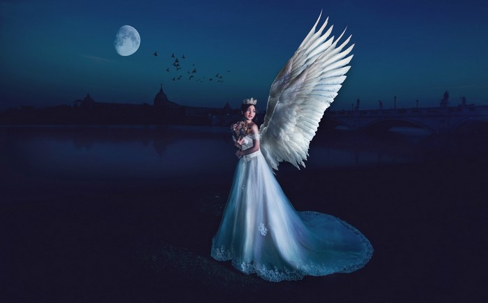 Angel in a white dress under the moonlight