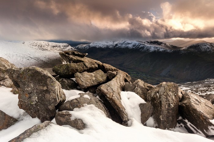 Snowy mountain ridge with dramatic clouds