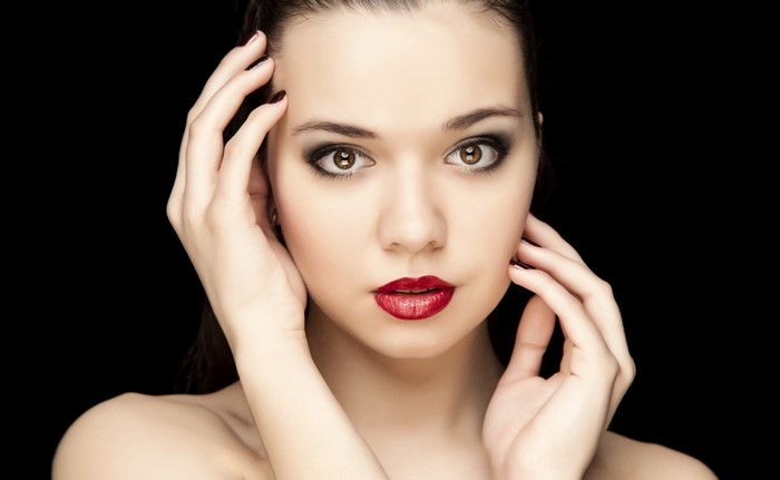 Woman with dramatic makeup and red lipstick