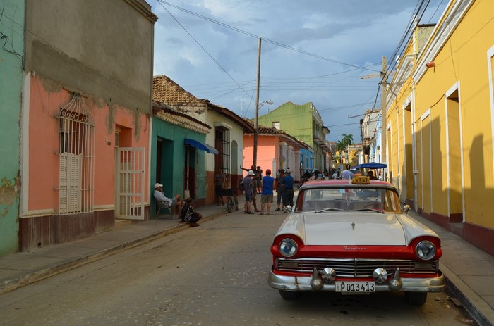 Vintage taxi car on a colorful street in Cuba
