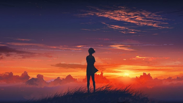 Silhouette of a person against a vibrant sunset sky
