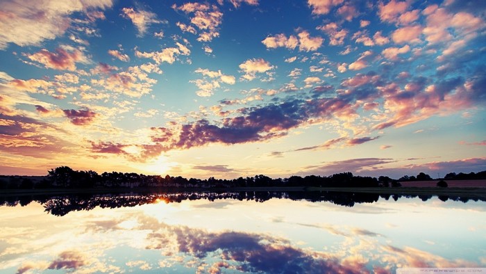 Sunset reflected in a lake with colorful clouds