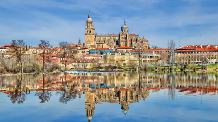 Salamanca Cathedral reflected in the Tormes River, Spain